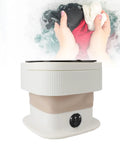 Ultra Compact Foldable Portable Washing Machine with Two In One Wash And Dry Combo Function with hands holding wet clothes.