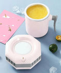 Self Heating And Cooling Smart Mug Keeps Your Beverage On Point With One Button 14 Oz Portable Thermoelectric Cup For Office Desk Home Use Ideal Gift In Fresh Green next to cooling device and fresh fruits.