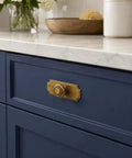 Top Shelf Antique Brass Cabinet Knobs With Killer Scalloped Backplates And Hella Durable Build For Fresh Kitchen And Bathroom Renovations Two Point Seven Five Inch Width Six Pack on blue kitchen drawer.