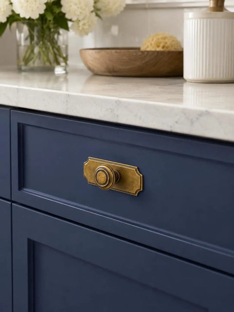 Top Shelf Antique Brass Cabinet Knobs With Killer Scalloped Backplates And Hella Durable Build For Fresh Kitchen And Bathroom Renovations Two Point Seven Five Inch Width Six Pack on blue kitchen drawer.