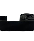 Adjustable Under Couch Gap Shield blocking toys dust and remotes, 10-foot flexible black roll for sofas and beds.
