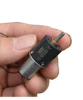 Close-up of a hand holding a 16mm 1215 planetary gearbox for DC motors, showcasing slow speed 36 RPM high torque reduction.