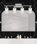 Sleek Modern 2 Light Vanity Light Fixture in matte black with clear glass shade, installed in bathroom above mirror.