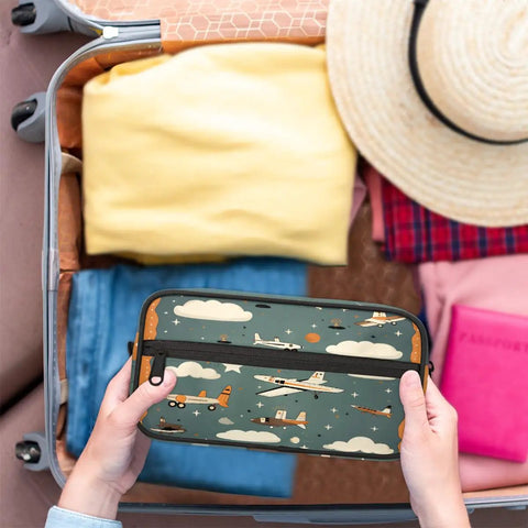 Hands holding Must Have Airplane Cosmetic Bag For Women, cute cartoon aircraft design, in open suitcase with clothes and hat
