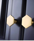 Close-up of two hexagonal knobs from 10 Pack 1.3 Inch Gold Cabinet Knobs Solid Brass Hexagon Drawer Pulls Brushed Brass Hardware for Kitchen Cabinets Drawers and Furniture Modern Update Stylish Upgrade For Any Decor