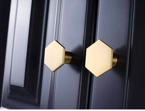 Close-up of two hexagonal knobs from 10 Pack 1.3 Inch Gold Cabinet Knobs Solid Brass Hexagon Drawer Pulls Brushed Brass Hardware for Kitchen Cabinets Drawers and Furniture Modern Update Stylish Upgrade For Any Decor
