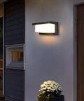 Outdoor Wall Porch Light LED Matte Black Exterior Lamp illuminating a porch, IP65 Waterproof, energy-efficient, 3-color temperature options.