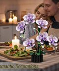 Couple dining with Purple Orchid Building Block Set With Vase, 619 Pieces, Phalaenopsis Floral Model Kit on table.