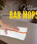 Hand wiping a kitchen counter with 60 Pack 16 By 19 Inch Terry Bar Mop Rags For Cleaning Absorbent And Durable Cotton Cloths