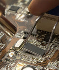 Close-up of All In One Soldering Station With Hot Air Rework, Power Supply And USB 3A Output, reworking a circuit board component.