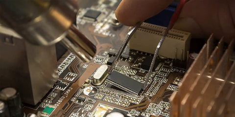 Close-up of All In One Soldering Station With Hot Air Rework, Power Supply And USB 3A Output, reworking a circuit board component.