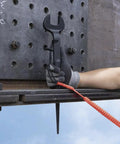 Worker using Workhorse Construction Spud Wrench With Tether Hole Made In USA 1-1/4 Inch Opening for bolt alignment on metal plate.