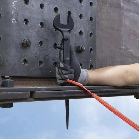 Worker using Workhorse Construction Spud Wrench With Tether Hole Made In USA 1-1/4 Inch Opening for bolt alignment on metal plate.