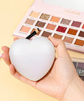 Person holding E Heart Shaped White Palette, part of Two Pack Resin Nail Art Palette With Gold Edge Mixing Tray For Nail Polish.
