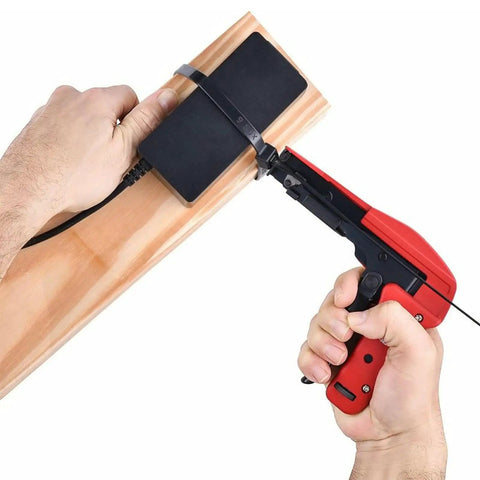 Person securing a cable with Heavy Duty Black Nylon Zip Ties 16 Inch 60 Lb Tensile 100 Pack Industrial Grade on a wooden board.