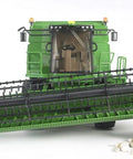 Front view of John Deere T670i Combine Harvester Toy For Kids With Ackermann Steering Tow Bar Realistic Farm Tractor Playset on rocks