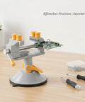 Versatile Mini Bench Vise With Suction Base For Jewelry And Electronics Repair holds a circuit board on a wooden desk.