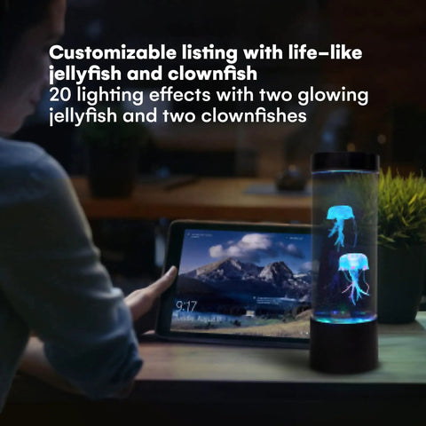 LED Jellyfish Lamp With Remote, 20 Color Changing LEDs, 2 Clownfish And 2 Jellyfish Figures, next to glowing tablet in dark room.