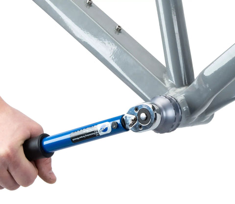 Hand using 16 Notch Bottom Bracket Tool for Quick Removal and Installation on a bike frame, fitting Shimano Ultegra BBR60 and Deore XT MT 800