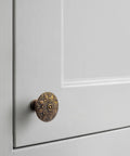 Six Pack Antique Brass Cabinet Knobs Featuring Intricate Vintage Mandala Design Ideal For Dressers Cabinets And Drawers Great For Restoring Antique Furniture And Creating Classic Farmhouse Style on gray cabinet door