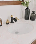 Black and gold widespread 8 inch bathroom faucet with water flowing, 3 hole sink mixer, brass pop up drain stopper, and supply lines visible