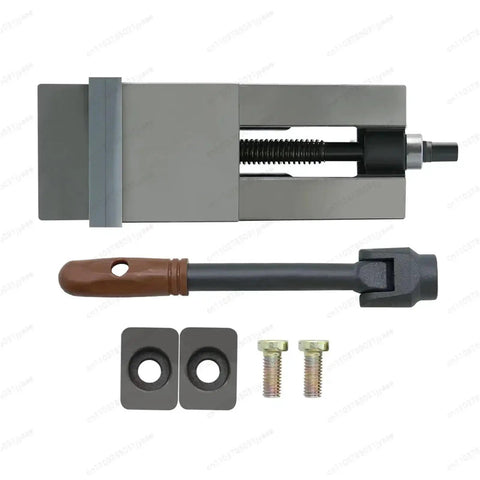 Dead Nuts Secure Six Inch Bench Vise With Hella Precision CNC Milling Clamping Jaw and accessories laid flat.