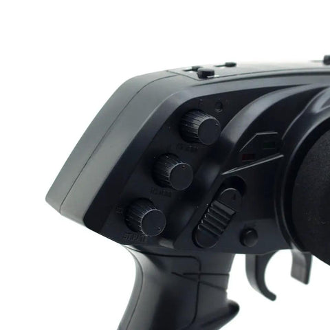 Close-up of 3 Channel 2.4G Anti-Jamming RC Transmitter controls for RC cars and boats, highlighting knobs and trigger