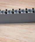 X20 12 Pin Terminal Block With Push In Connectors 10 Amp Heavy Duty Industrial Panel Wiring, grey housing on wooden surface.