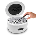 Hand placing eyeglasses into Beast Pro-Grade Ultrasonic Jewelry Cleaner With 25-Ounce Tank, Waterproof Design, 50,000 Hz Power