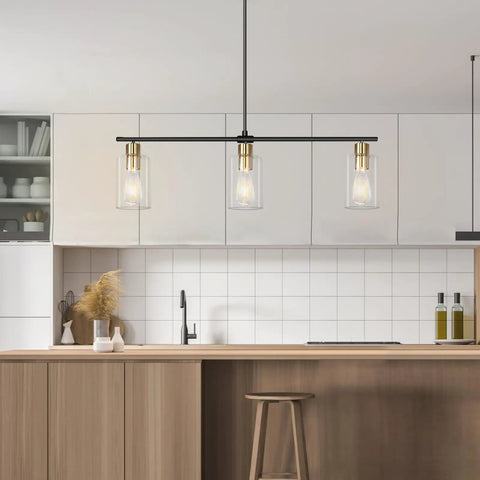 Three Light Linear Farmhouse Kitchen Island Lighting In Black And Gold Finish With Glass Shades above modern kitchen island.