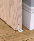 4 Pack POM Plastic T Shape Adjustable Sliding Barn Door Floor Guides with Screws White Finish installed under wooden door