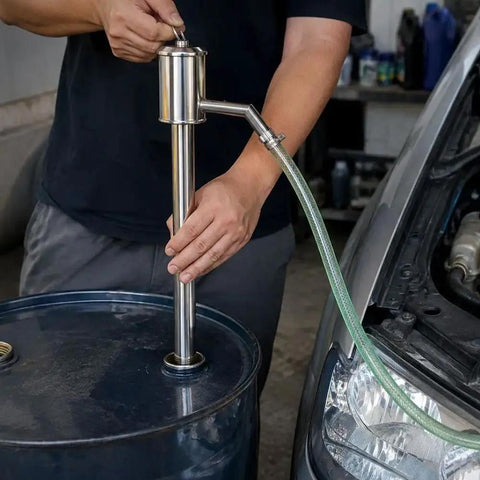 Hand Operated Manual Fluid Transfer Pump Stainless Steel Portable Siphon for Gas, Oil And Water in use with a barrel.