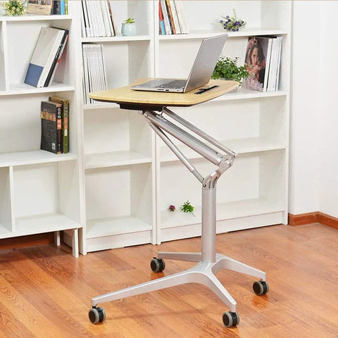 Hassle Free Pneumatic Sit Stand Laptop Desk Cart With Smooth Lever Adjustments Solid Rolling Ergonomic Mobile Workstation And No Fuss Stability For Home Office Study, featuring a laptop on a wooden top in a cozy room.