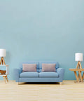 Cozy Kids Table Lamp With Fabric Shade And Wood Tripod Base next to a blue couch in a modern living room setting