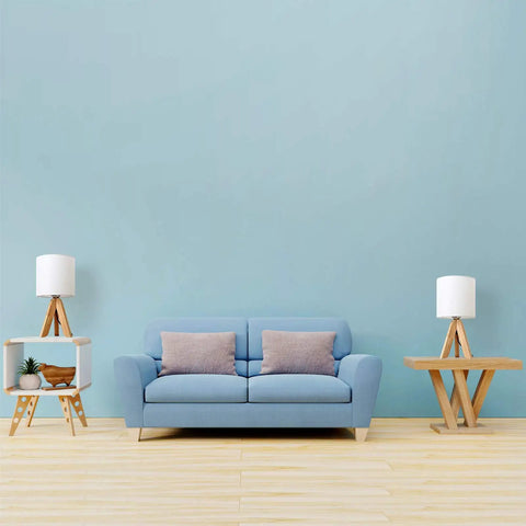 Cozy Kids Table Lamp With Fabric Shade And Wood Tripod Base next to a blue couch in a modern living room setting
