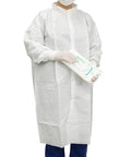 Premium Disposable Cleanroom Lab Coat For Adults Built Tough With A Legit Lint Free Shield Featuring Thumb Loop Sleeves and Snug Knit Cuffs For Daily Grind Comfort Crisp White Micro Mesh Solid Guard 10 Pack worn by a person holding wipes.