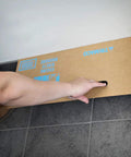 Person holding Disposable Cardboard Spray Shield Pack Of 50 10 Inch By 31 Inch Absorbent Shield For Clean Edges While Painting against wall