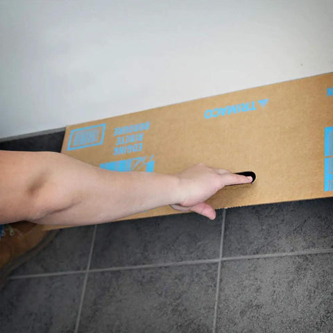 Person holding Disposable Cardboard Spray Shield Pack Of 50 10 Inch By 31 Inch Absorbent Shield For Clean Edges While Painting against wall