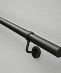 Rock Solid Steel Staircase Handrail Six And A Half Feet Long No Sweat Wall Mount Indoor Safety Railing With Grippy Matte Black Coating close-up of mounting hardware.