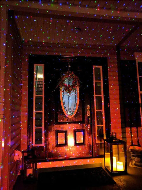 Outdoor Christmas Laser Projector Lights With Remote Control RGB firefly motion effects illuminating a porch with red, green, blue beams.