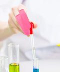 Person using Premium Latex Finger Cots 100 Pack Anti Static Breathable Protective Covers while handling a dropper over test tubes.