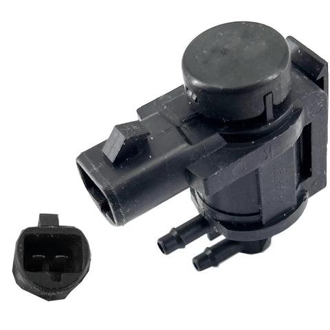 Black automotive hub-lock vacuum solenoid actuator with circular top and dual hose ports, front view.