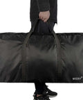 Person carrying Roomy 96L Duffle Bag For Men And Women Foldable Waterproof Travel Gear Rugged Honeycomb Nylon Build Black