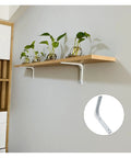 Heavy Duty Wall Mounted Metal Shelf Brackets Flat Out Reliable Furniture Supports in use with a wooden shelf and plants.