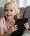 Child holding Padded Bubble Mailers 5 By 8.6 Inches, 50 Pack Self Seal Envelopes with Extra Thick Padding, Black, on couch
