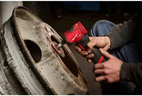 Person using Top Tier Quarter Inch Cordless Right Angle Die Grinder With Brushless Motor and Snappy Trigger on a metal wheel.