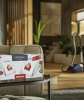 HyClean Air FJM Vacuum Bags For Compact C1 And C2 Canisters box on table in living room with vacuum cleaner in background