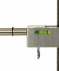 Close-up of Heavy Duty Pipe Hole Punch Device For Copper Steel And PVC showing metal mount and level on black pipe.