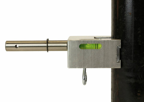 Close-up of Heavy Duty Pipe Hole Punch Device For Copper Steel And PVC showing metal mount and level on black pipe.