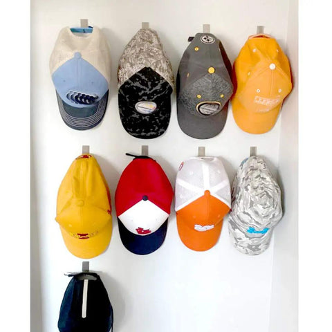 Ultra Strong Stainless Steel Adhesive Hooks For Wall Mounting Holds Hats Caps Keys And Kitchen Utensils Up To 5 Lb Waterproof Wall Rack Hooks 20 Pack For Kitchen Bathroom Cabinets with multiple hats displayed.